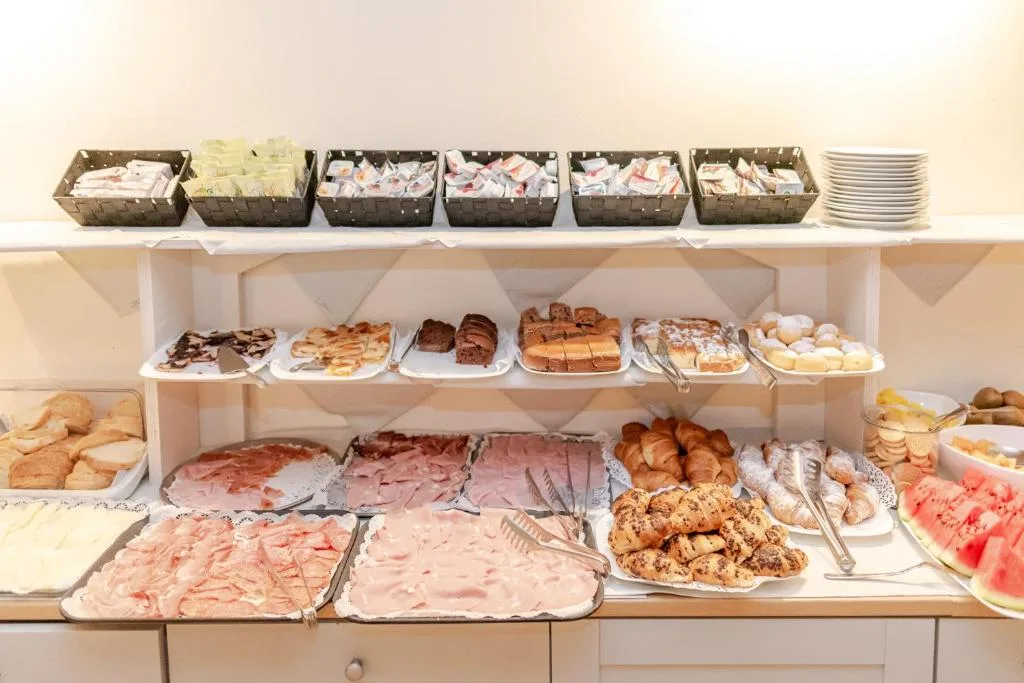 Dettaglio del buffet con affettati, cornetti e torte fatte in casa